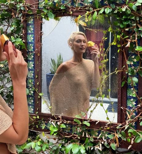 Bella Hadid Stuns in Sheer Cropped Shawl for Perfume Event
