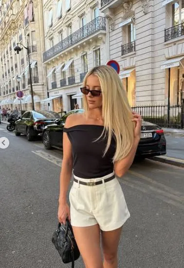 Brewer stands in front of a water fountain during her Paris vacation