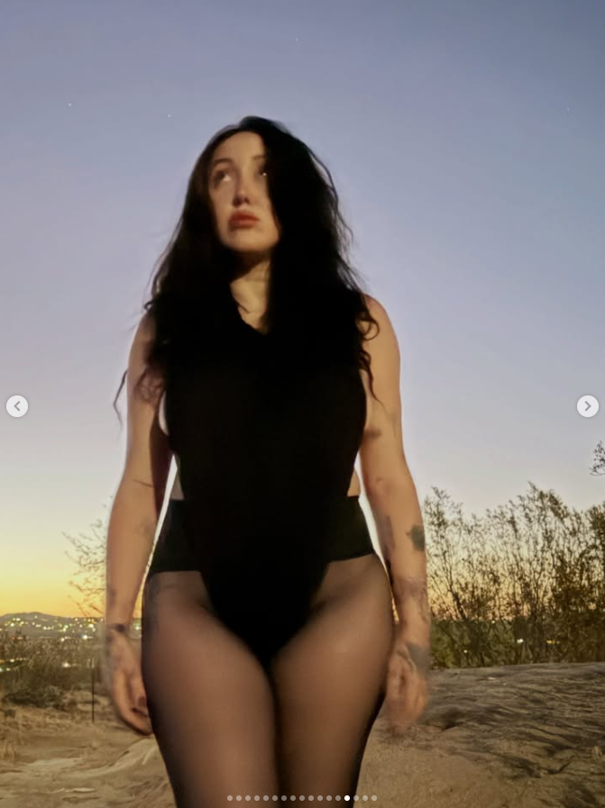 Noah Cyrus Stuns in Edgy Black Bodysuit During Striking Desert Photoshoot 2 For some snaps, Noah moved her bodysuit away from her chest and covered her bare boob with one hand